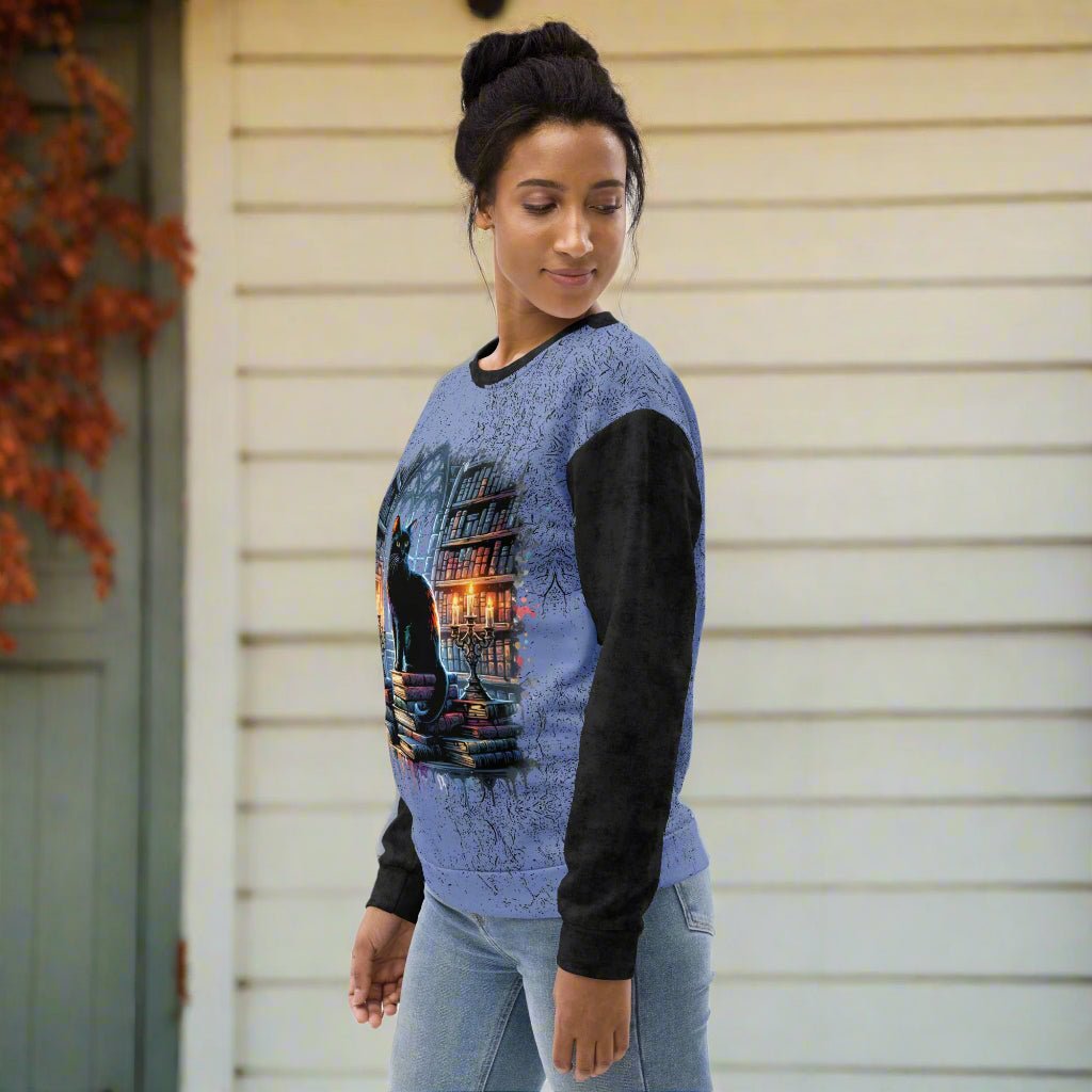 Woman wearing a blue and black sweater with a graphic design on a white background
