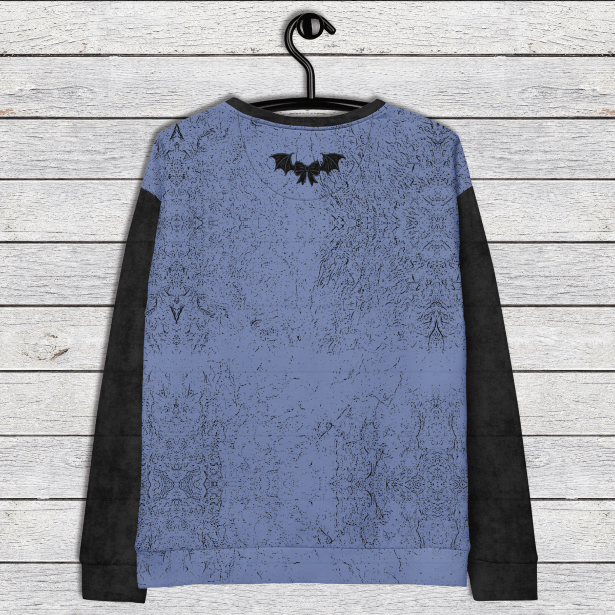 Blue long-sleeve shirt with black accents on a wooden surface