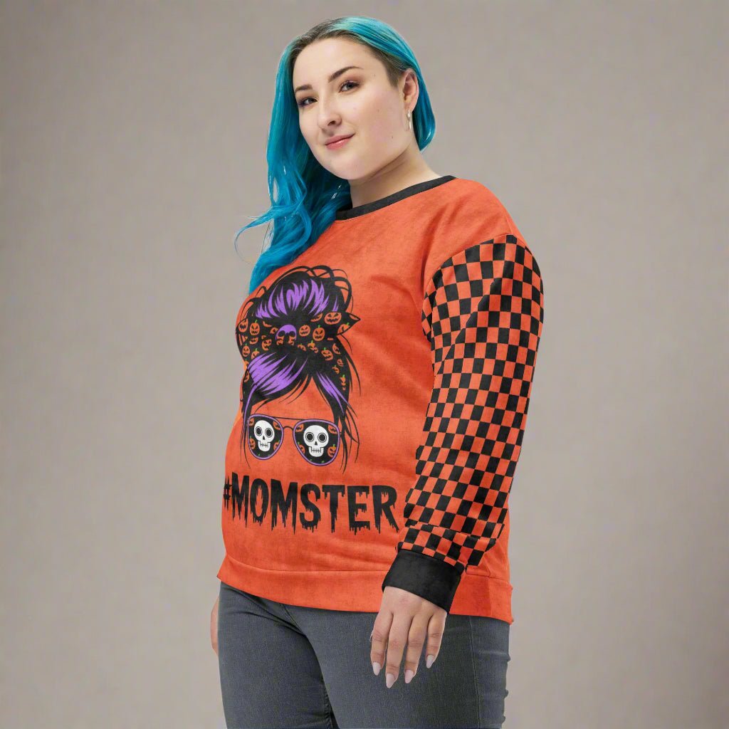 Person wearing an orange sweatshirt with a graphic design and 'MOMSTER' text on a white background