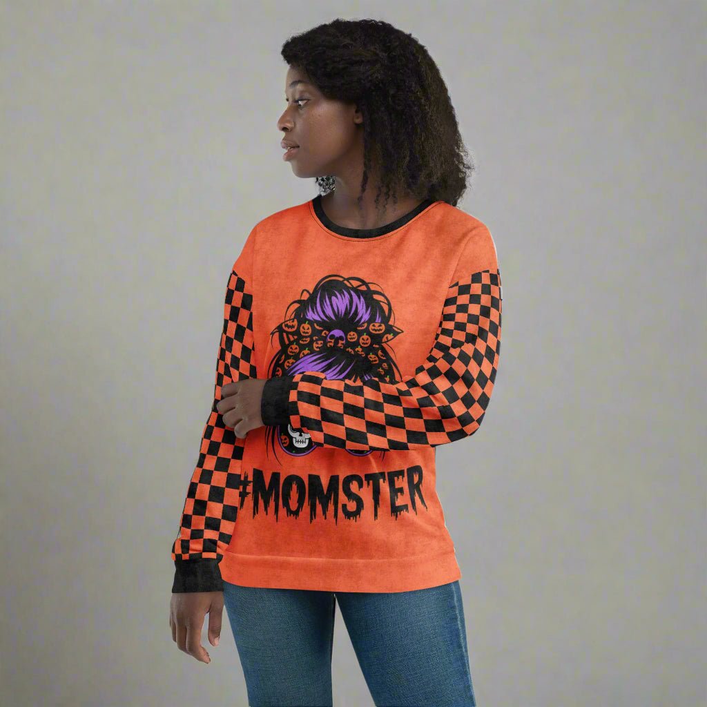 Person wearing an orange long-sleeve shirt with a graphic design and text on a white background