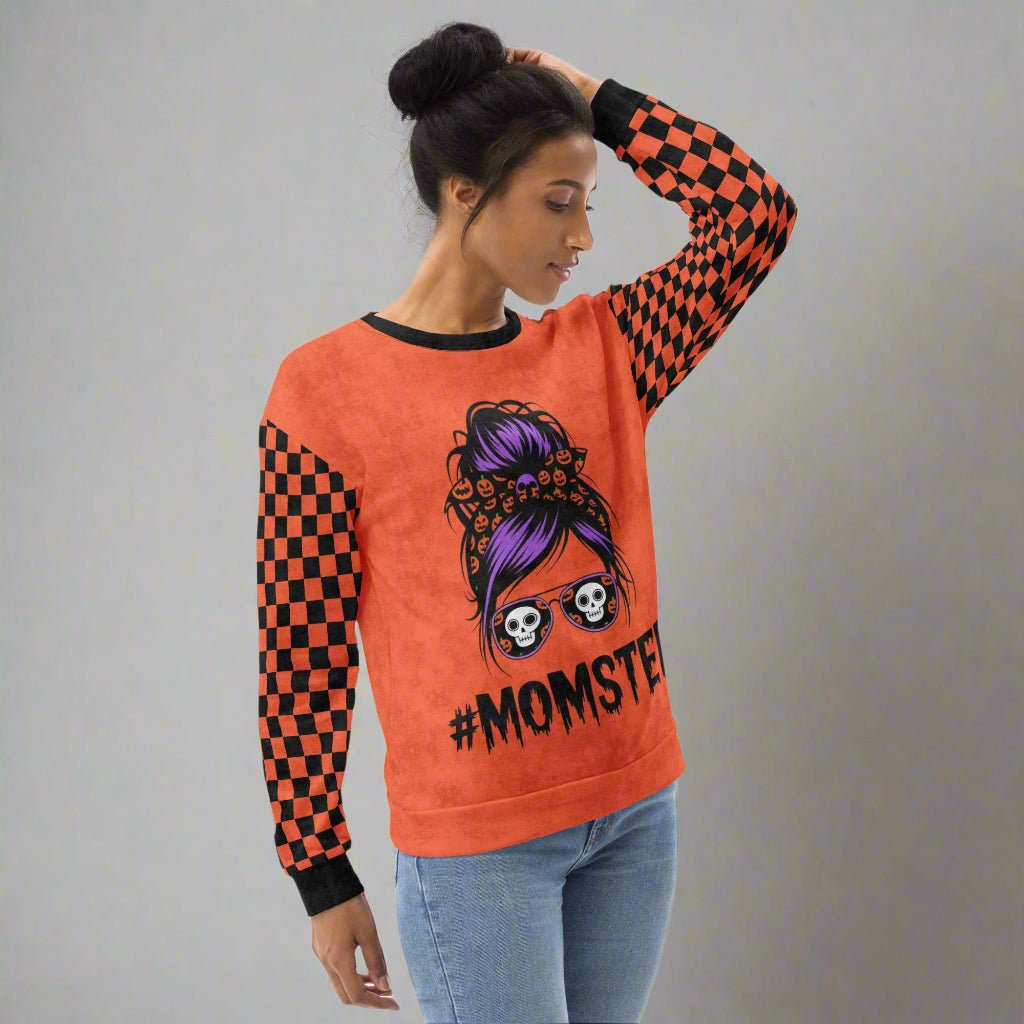 Woman wearing an orange sweatshirt with a graphic design and text on a white background