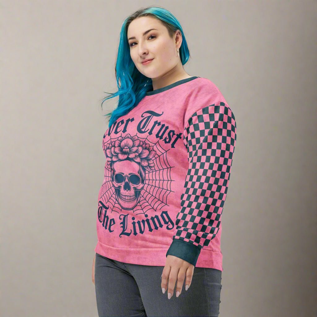 Person wearing a pink long-sleeve shirt with charcoal text and designs on a white background