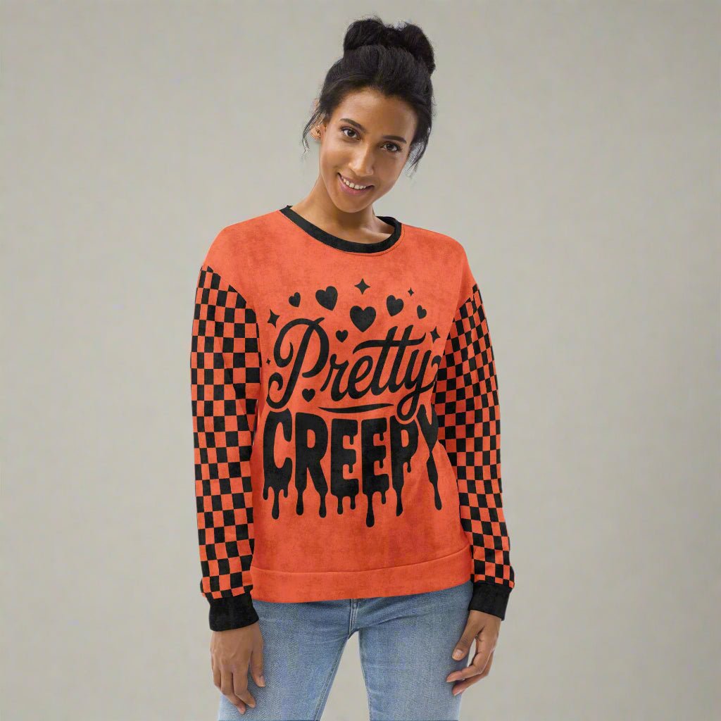 Person wearing a red and black checkered sweater with 'Pretty Creepy' text on a neutral background