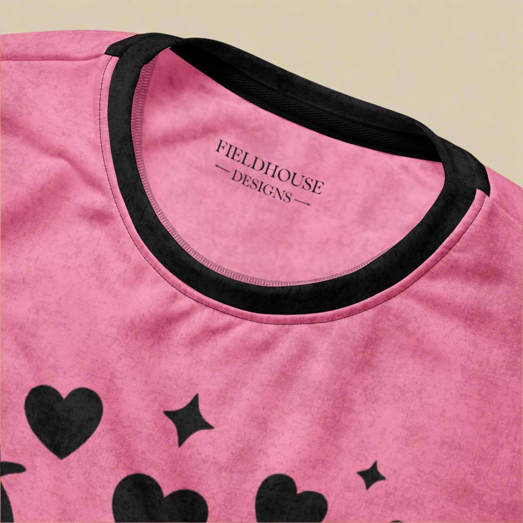 Pink shirt with black hearts and stars and 'Fieldhouse Designs' branding.