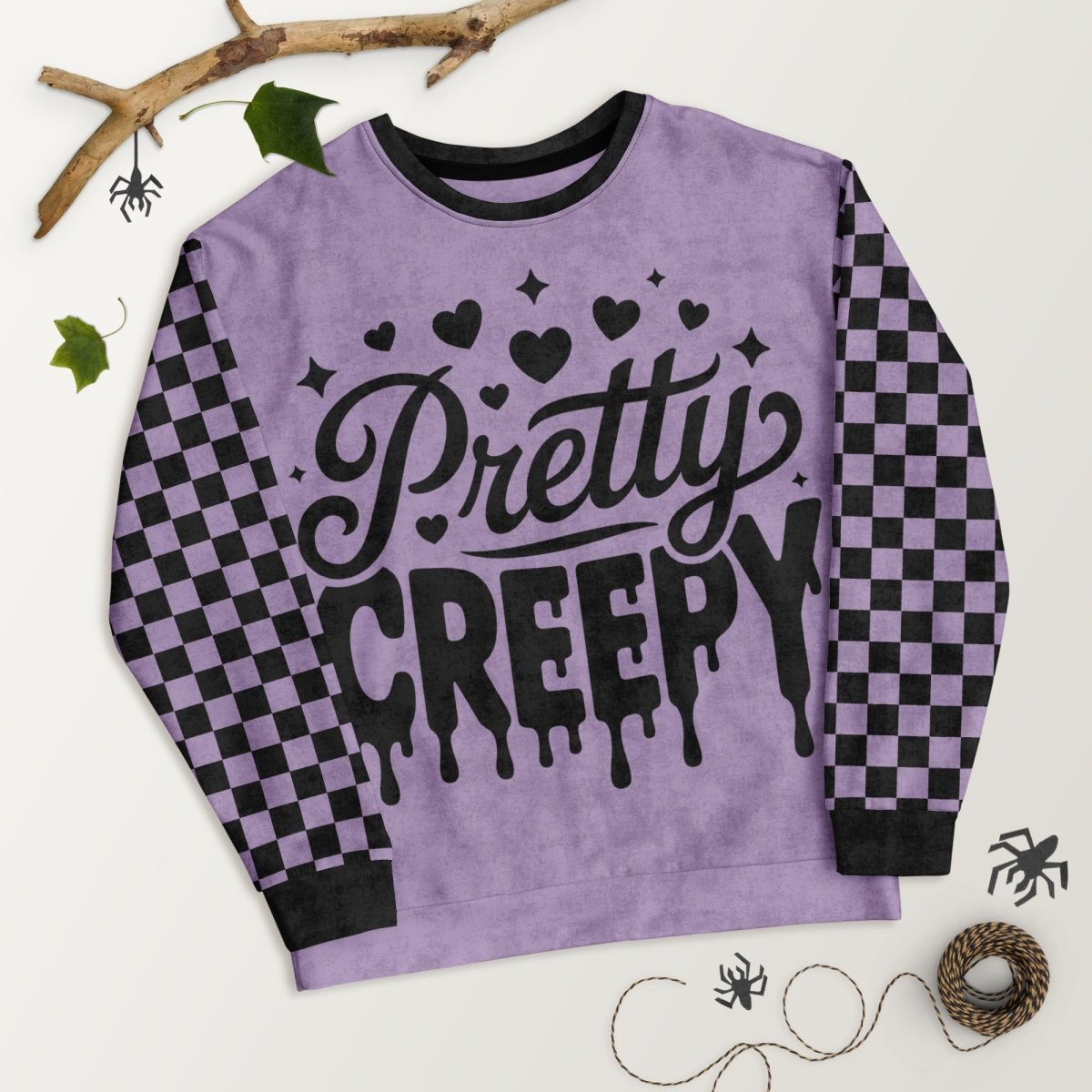 Purple sweatshirt with 'Pretty Creepy' text on a white background