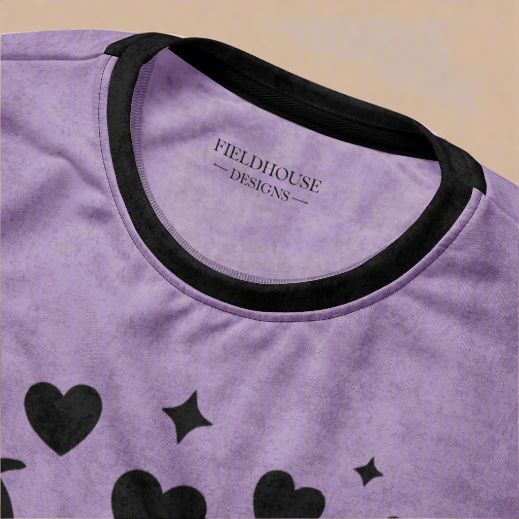 Purple shirt with black hearts and stars and 'Fieldhouse Designs' branding.