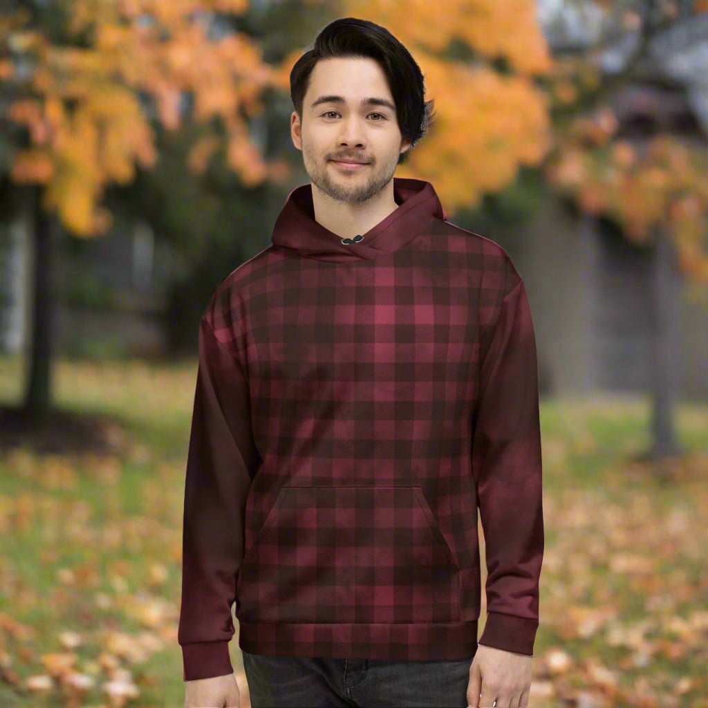 Person wearing a burgundy and black plaid hoodie outdoors