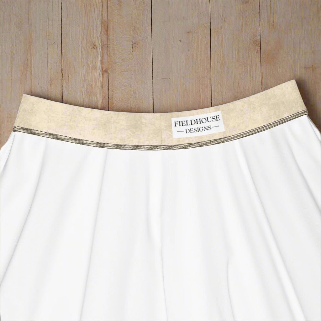 beige waistband and 'Fieldhouse Designs' label on a wood