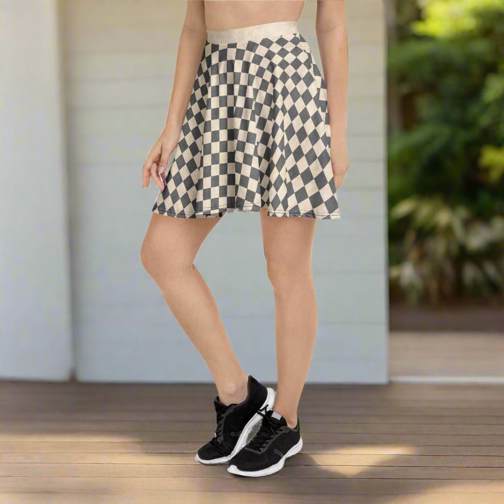 Person wearing a checkered skirt and black sneakers on a white background