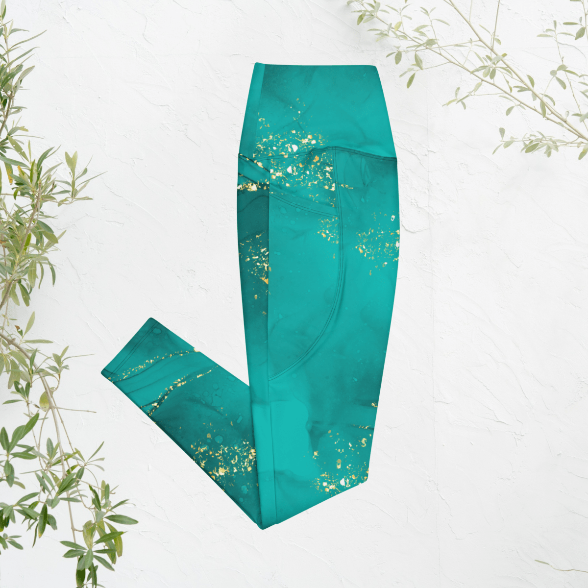 Teal leggings with gold speckles on a white background