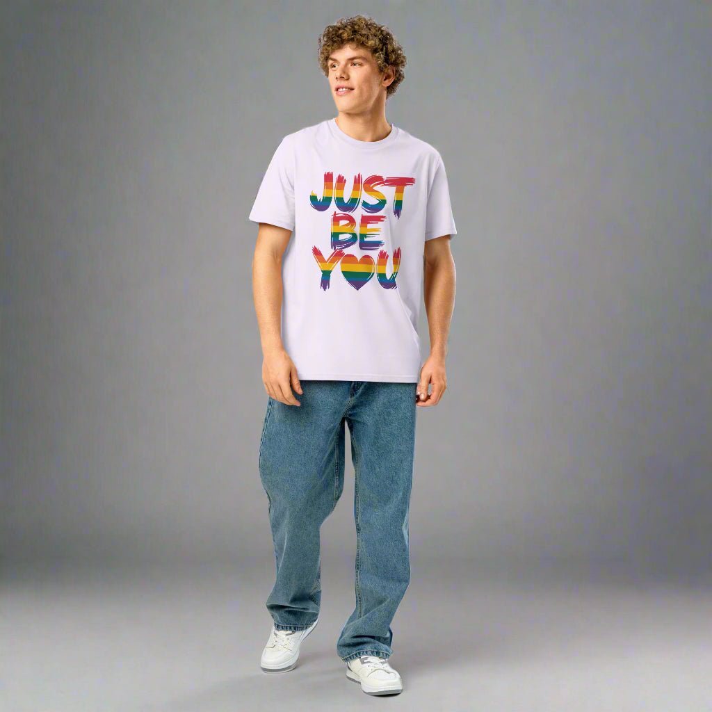 Person wearing a lavender t-shirt with 'JUST BE YOU' text in colorful letters on a white background