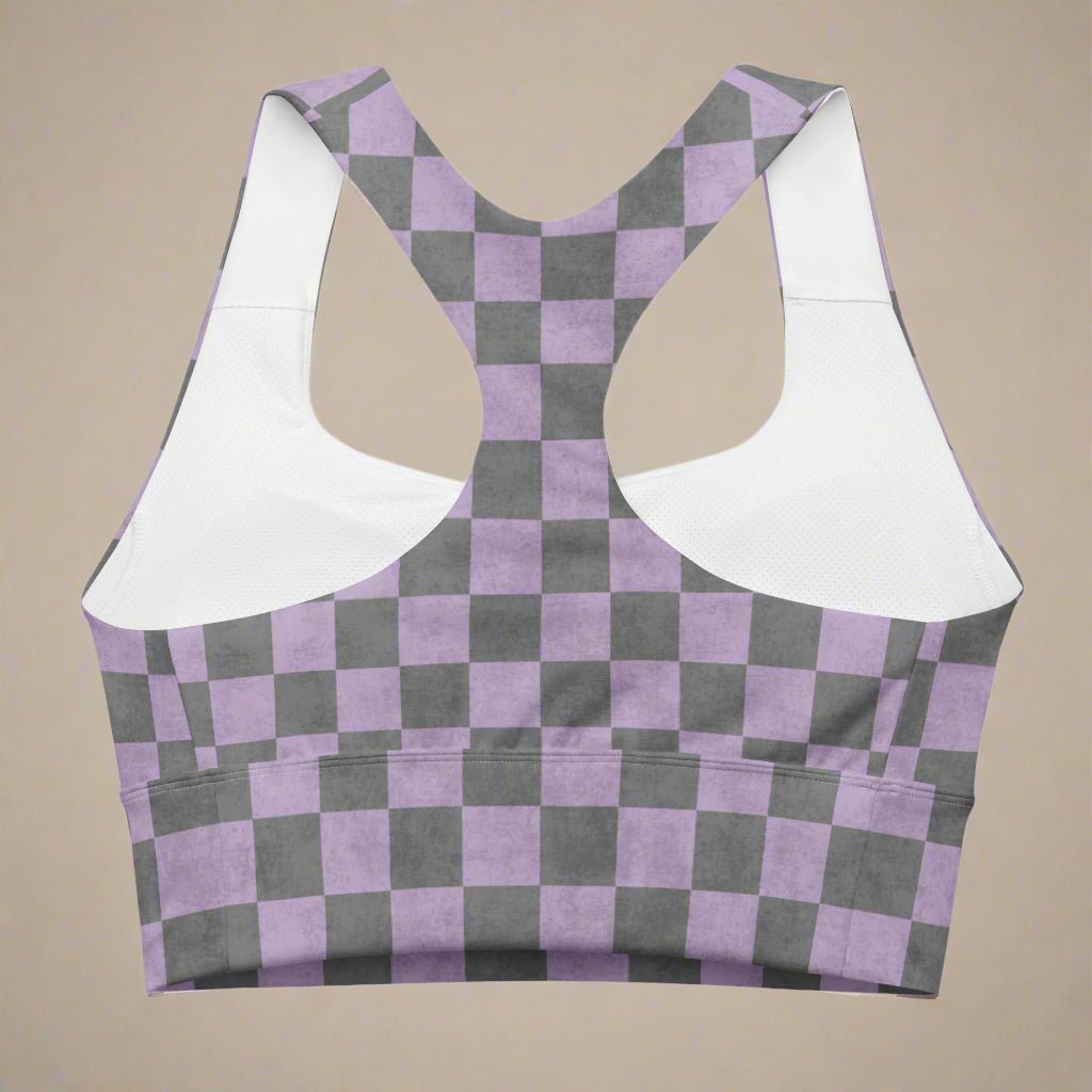 Checkered sports bra with purple and gray pattern on a beige background