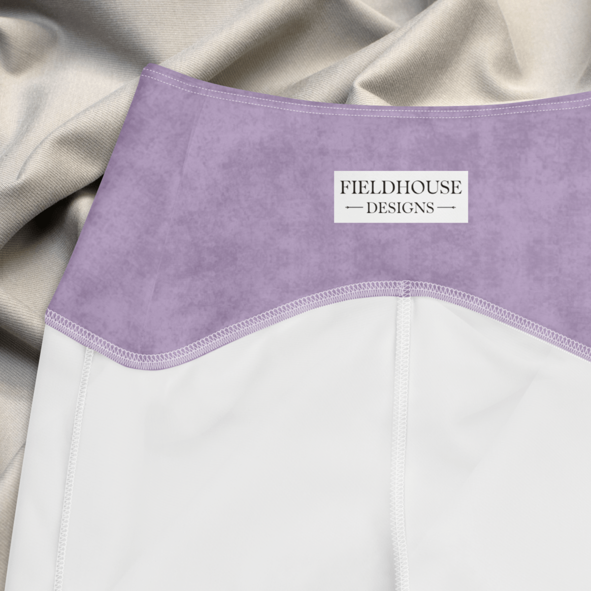 Purple waistband with 'Fieldhouse Designs' label on a beige background