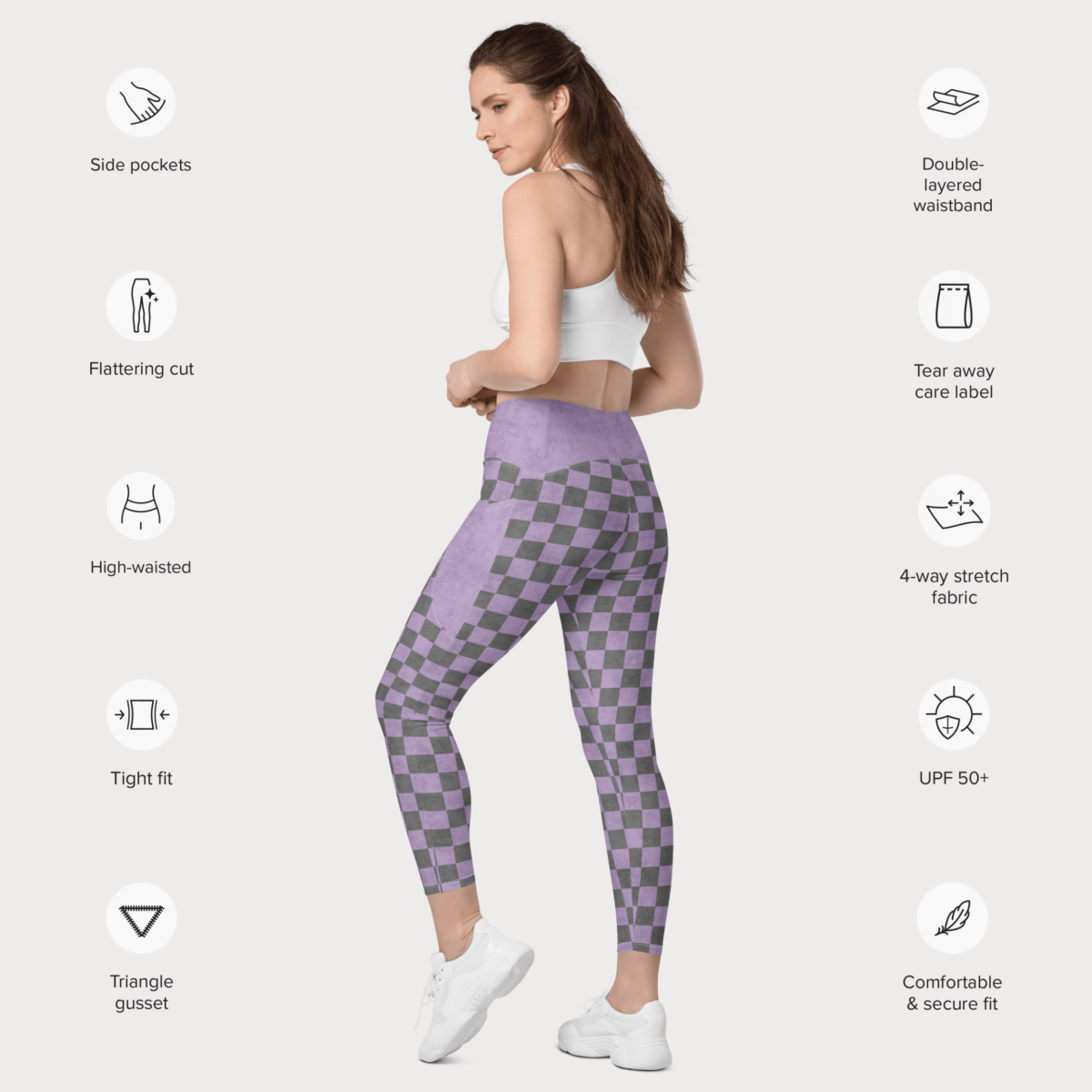 Woman wearing purple checkered leggings with feature icons on a white background