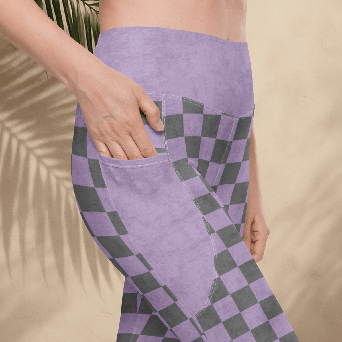 Person wearing purple and gray checkered checkered with a beige background