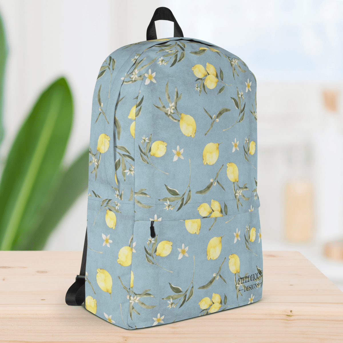 Backpack with lemon and floral pattern on a light blue background