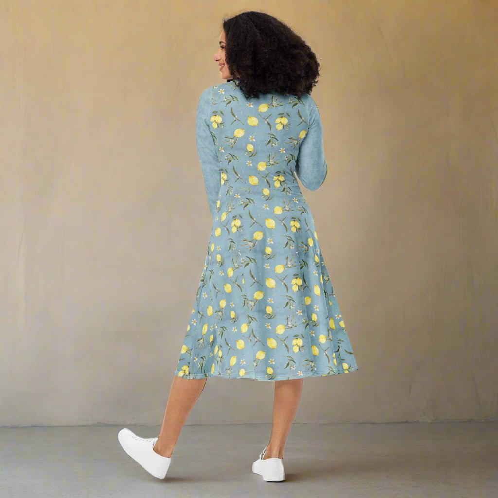 Woman wearing a blue floral dress against a beige background
