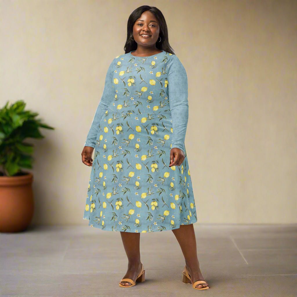 Woman wearing a blue floral dress standing against a plain background