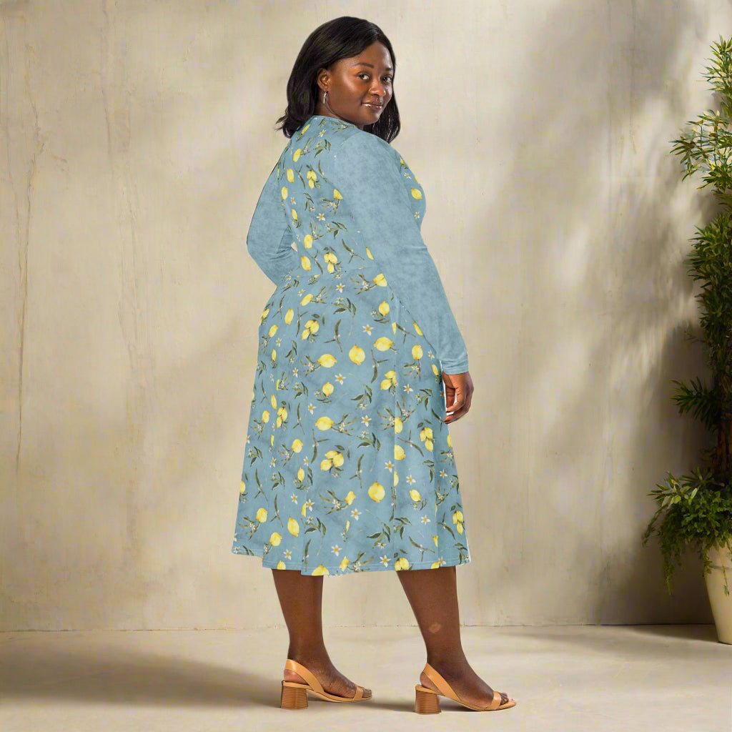 Woman wearing a blue floral dress standing against a neutral background