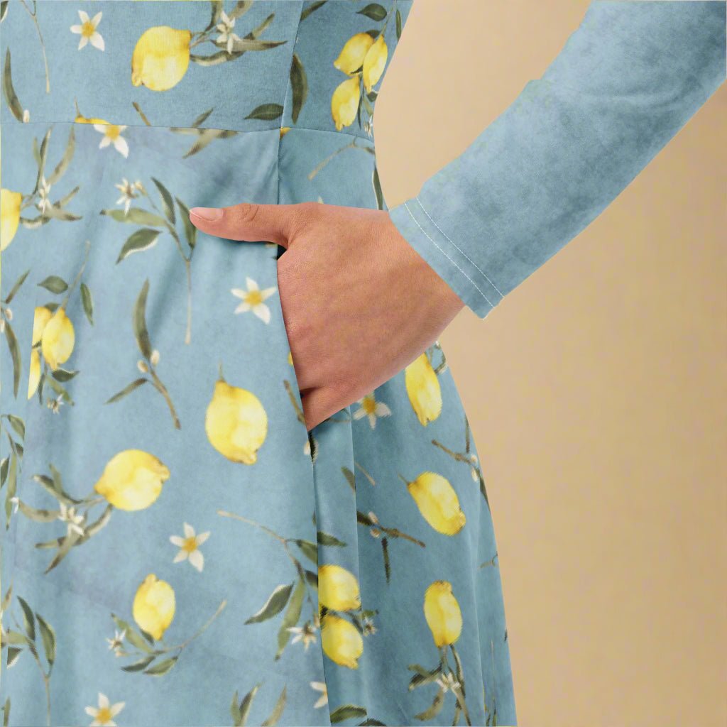 Blue dress with lemon and flower pattern worn by a person