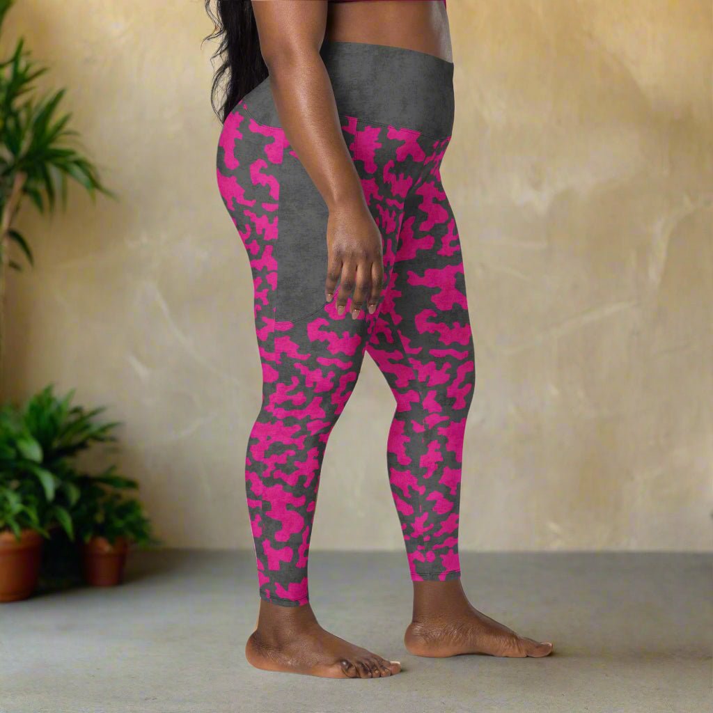 Person wearing pink and gray camouflage leggings with a neutral background