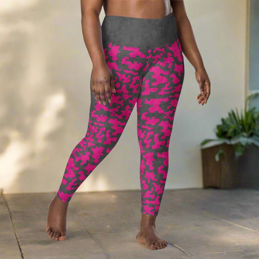 Person wearing pink and gray camouflage leggings outdoors.