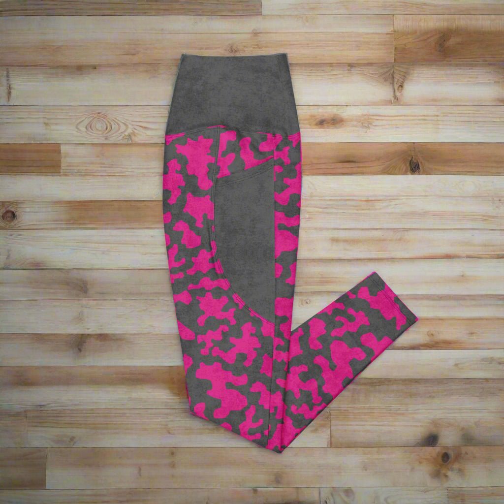 Gray leggings with pink camouflage pattern on a wooden surface
