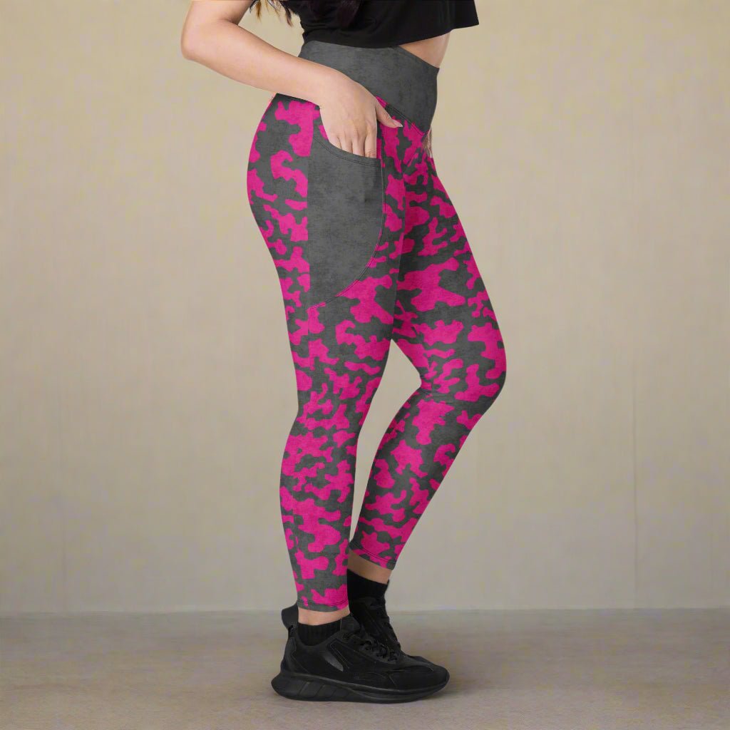 Person wearing pink and gray camouflage leggings on a neutral background