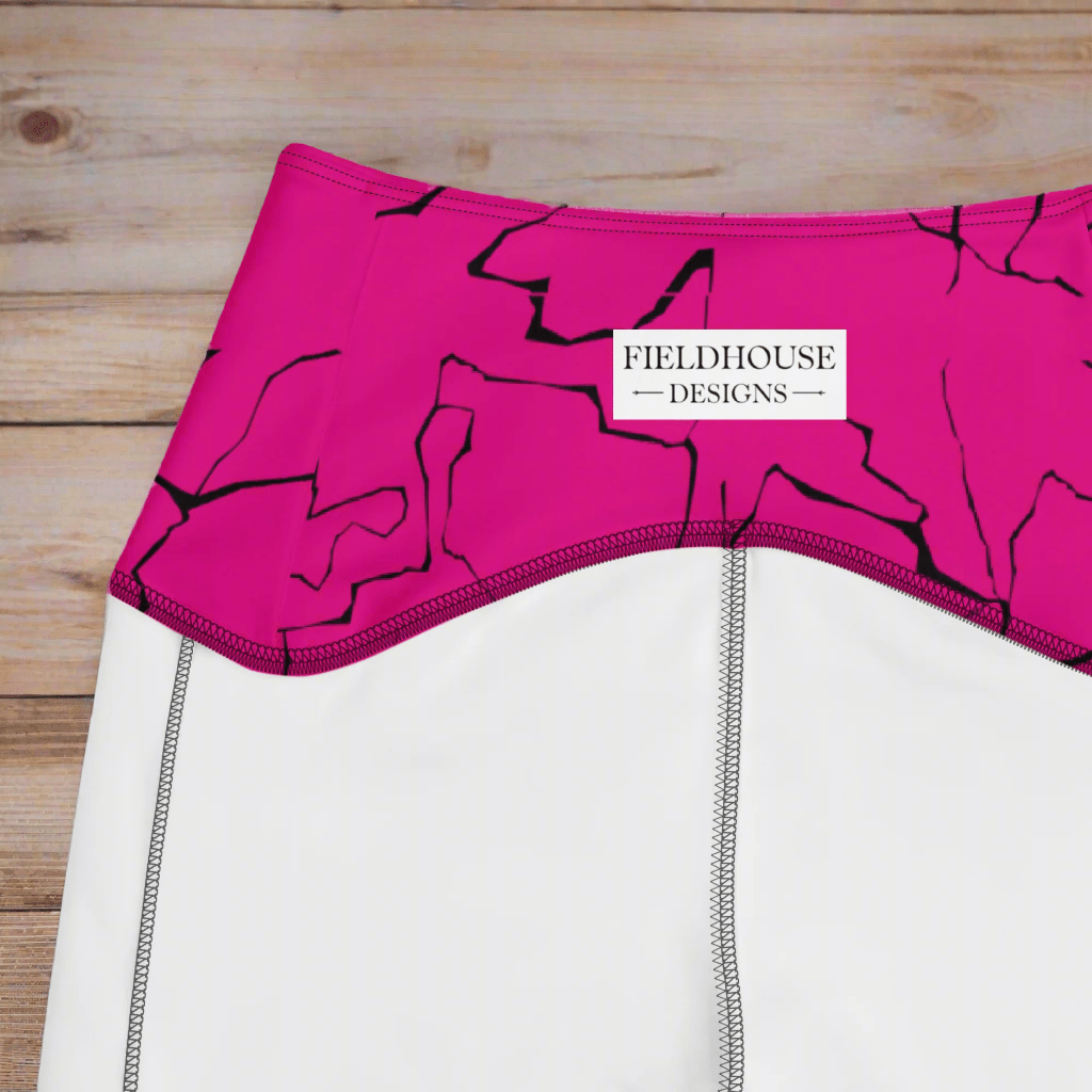 Close-up of a pink waistband with 'Fieldhouse Designs' label on a wooden surface
