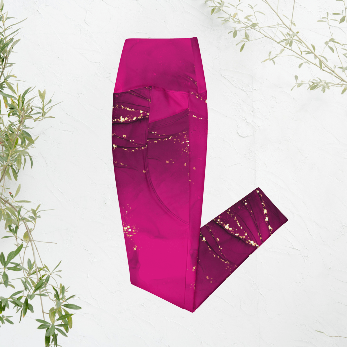 magenta leggings with gold accents on a white background