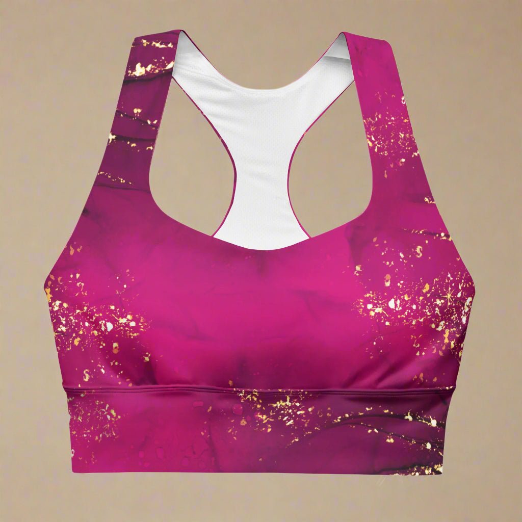 Pink sports bra with gold glitter pattern on a beige background