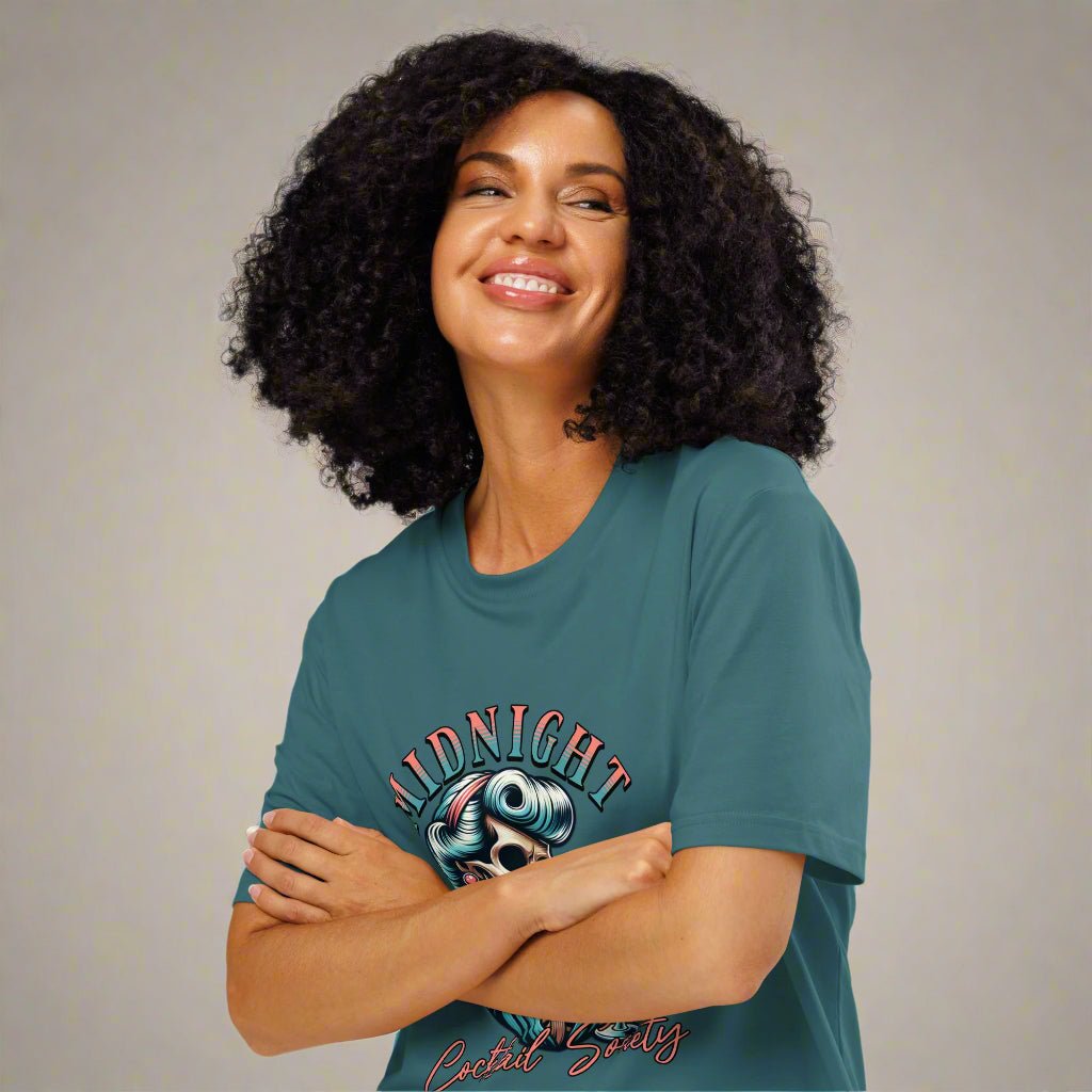 Woman wearing a teal t-shirt with a graphic design on a white background