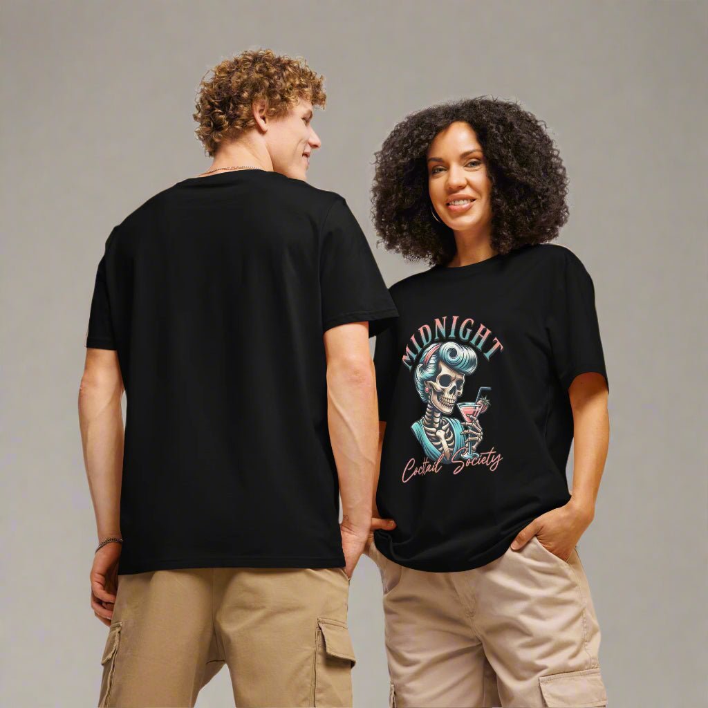 Two people wearing black t-shirts with a design on a plain background