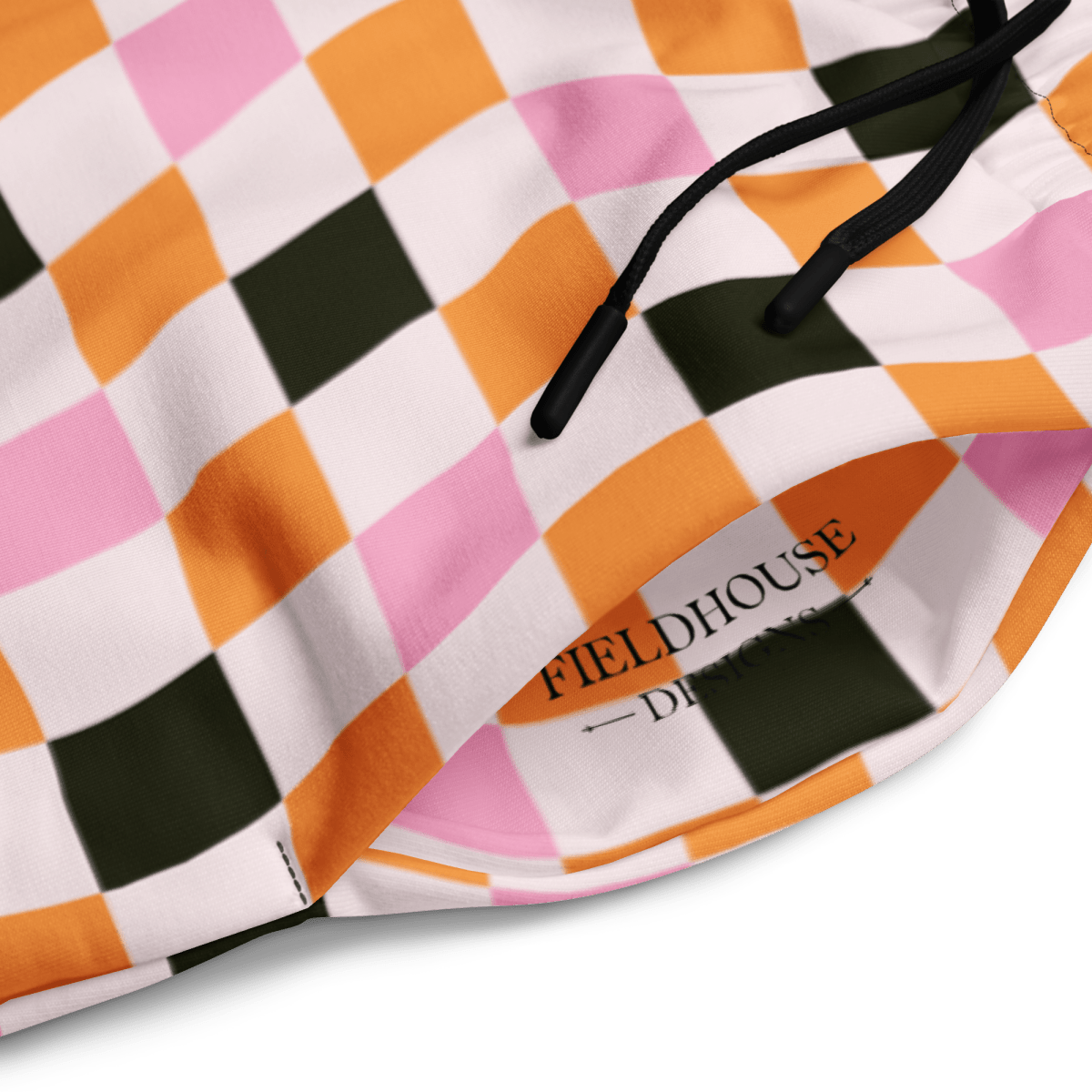 Close-up of a checkered pattern on wide leg joggers with 'Fieldhouse' branding.