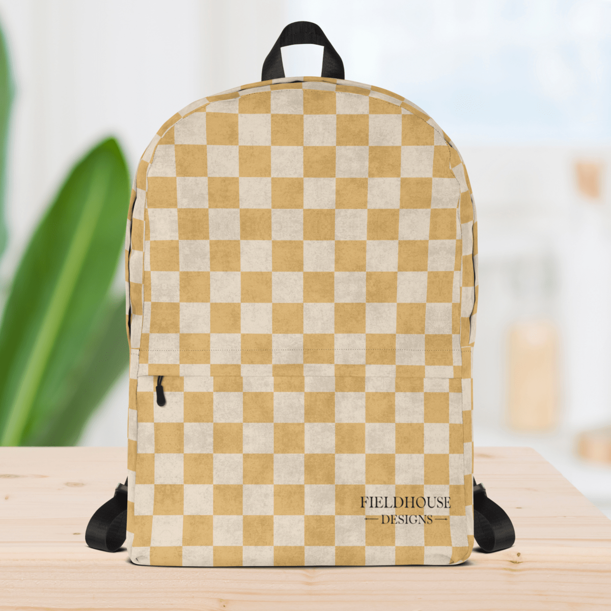 Checkered backpack with 'Fieldhouse Designs' logo on a wooden surface