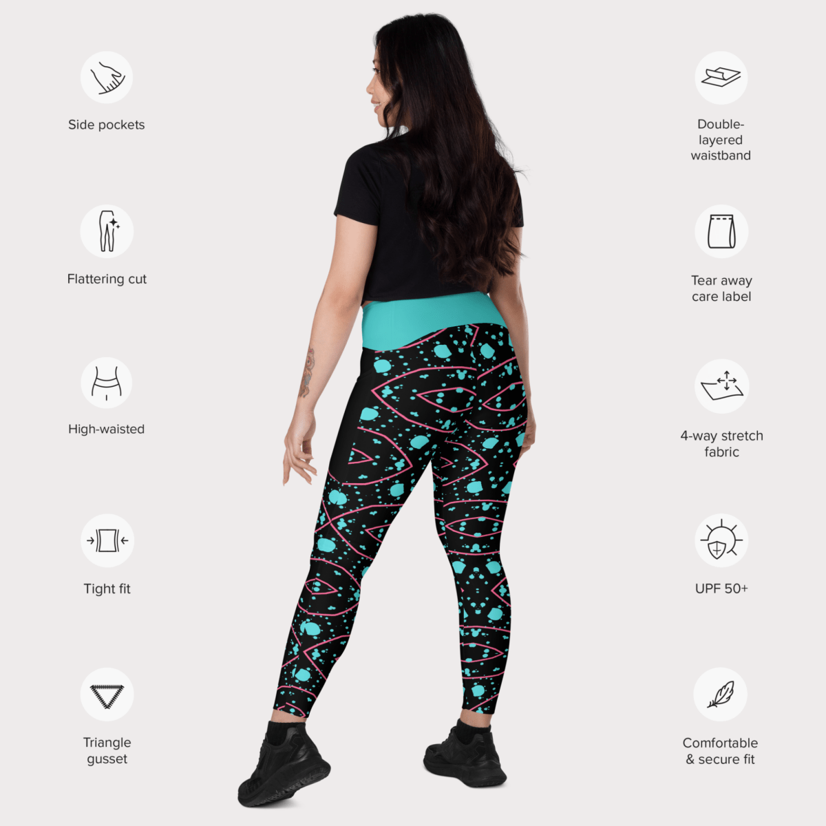 Woman wearing black patterned leggings with feature icons on a white background