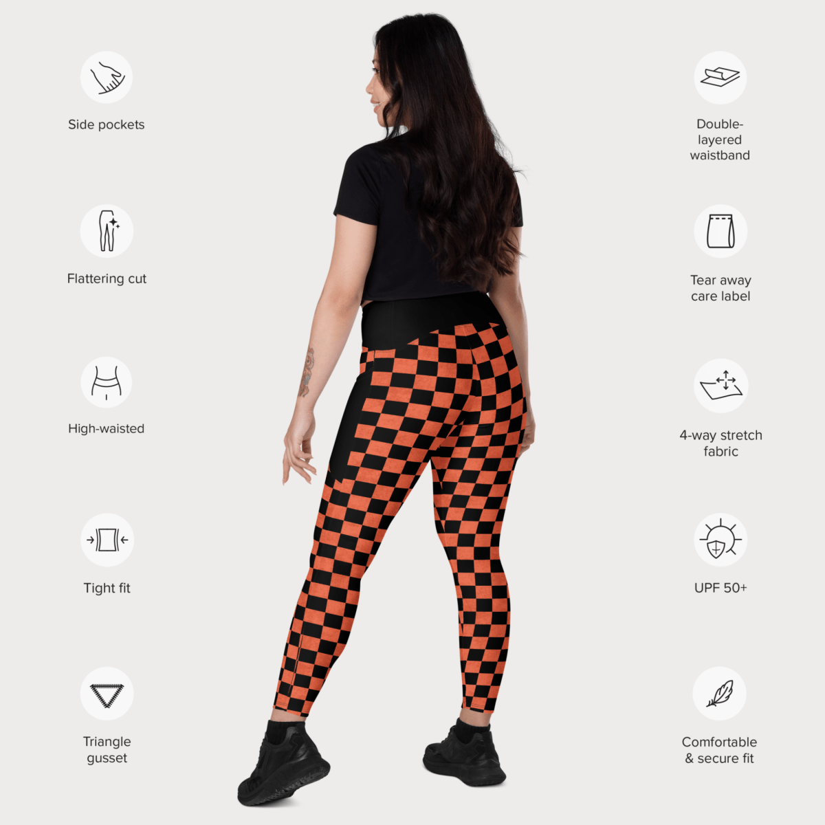 Person wearing black and orange checkered leggings with feature icons on a white background