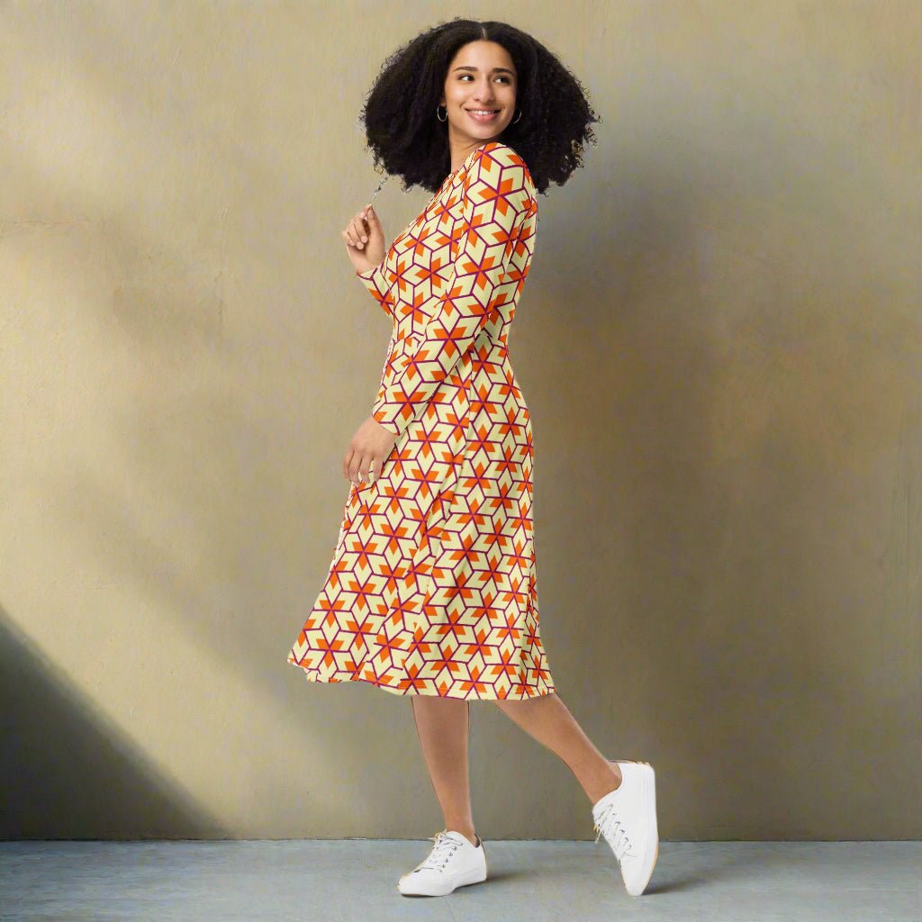 Woman wearing a patterned dress with white sneakers against a beige background