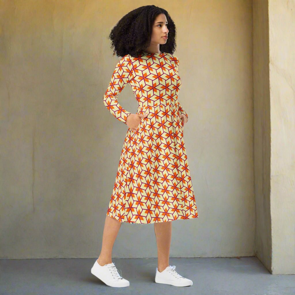 Woman wearing a patterned dress with geometric design on a beige background