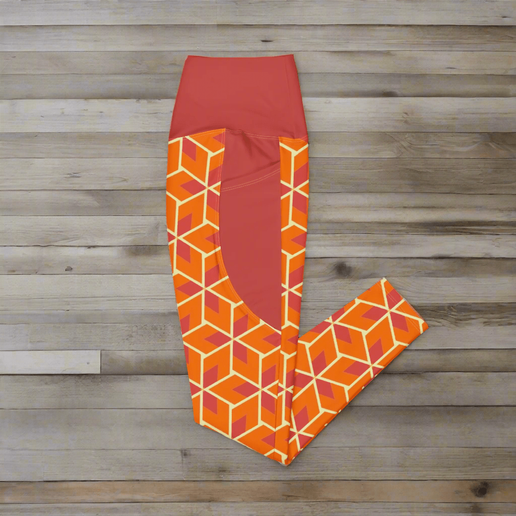 Orange and red geometric patterned leggings on a wood background