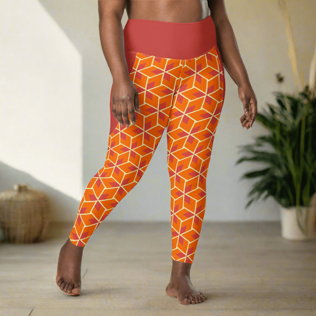 Person wearing orange geometric patterned leggings indoors with a plant in the background