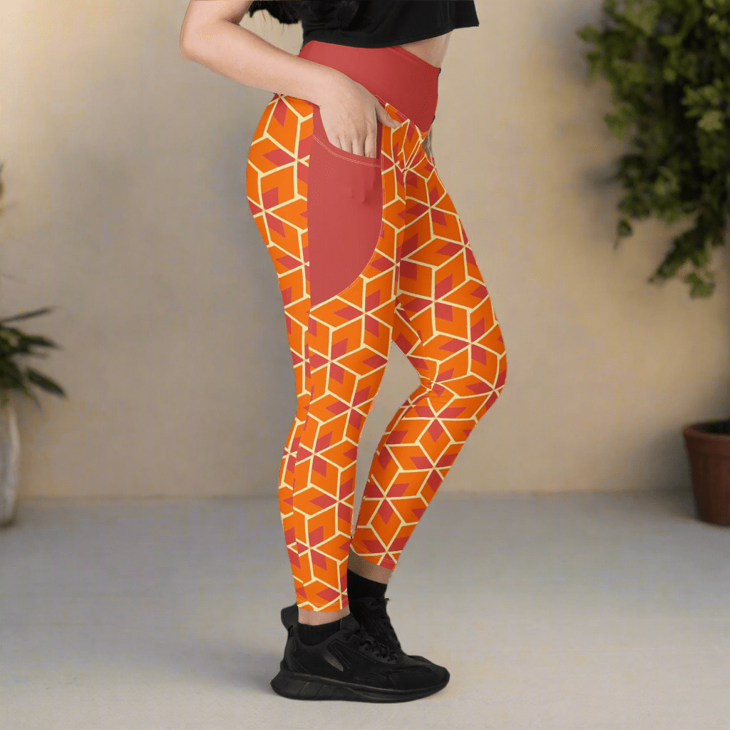 Orange geometric patterned leggings worn by a person on a neutral background