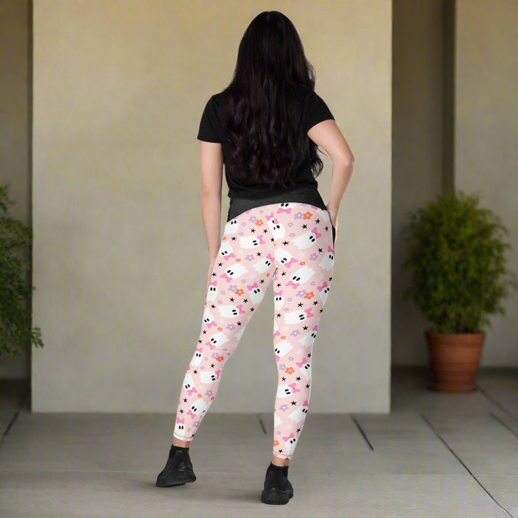 Woman wearing pink ghost leggings with a neutral background