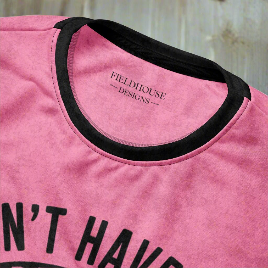 Pink t-shirt with black text and neckline, featuring 'Fieldhouse Designs' branding.