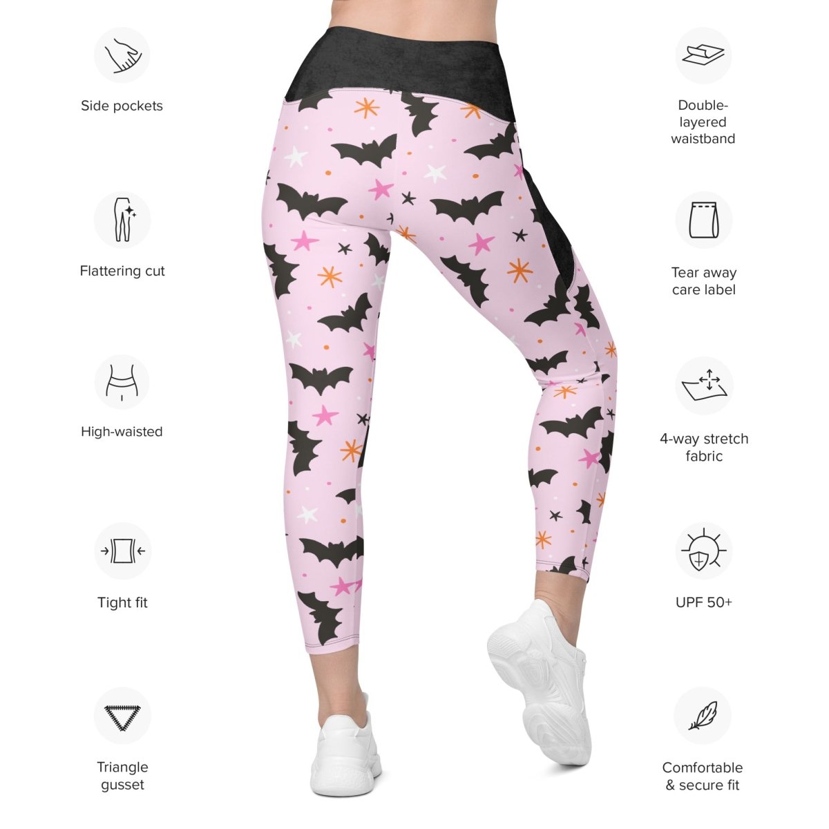 Pink leggings with black bat pattern on a white background with feature icons.