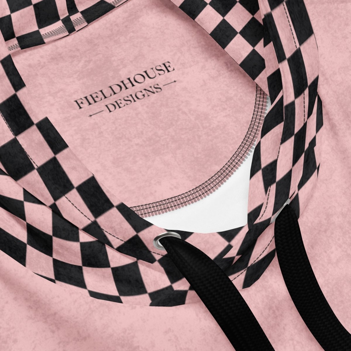 Pink hoodie with black checkered pattern and 'Fieldhouse Designs' branding.