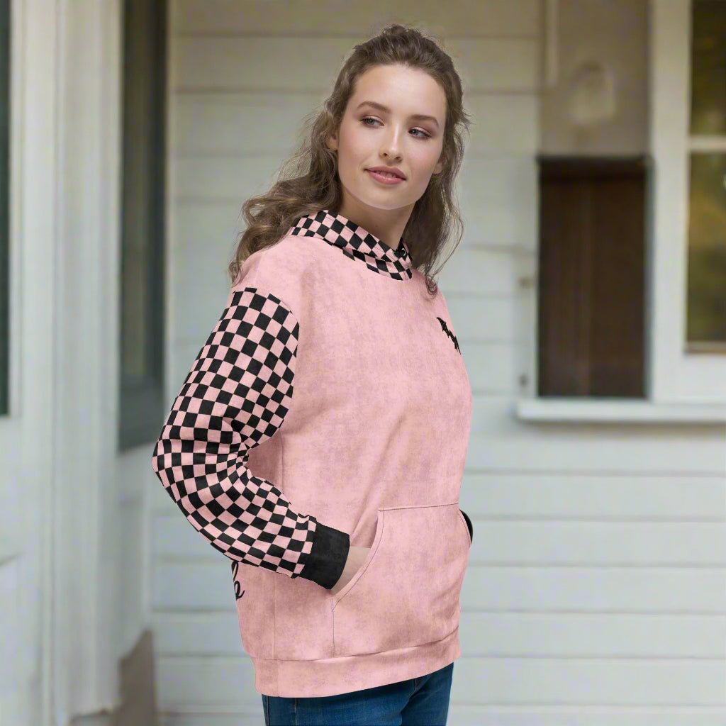 Woman wearing a pink hoodie with checkered sleeves on a white background