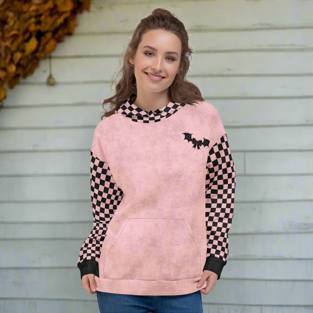 Person wearing a pink hoodiewith checkered sleeves on a white background
