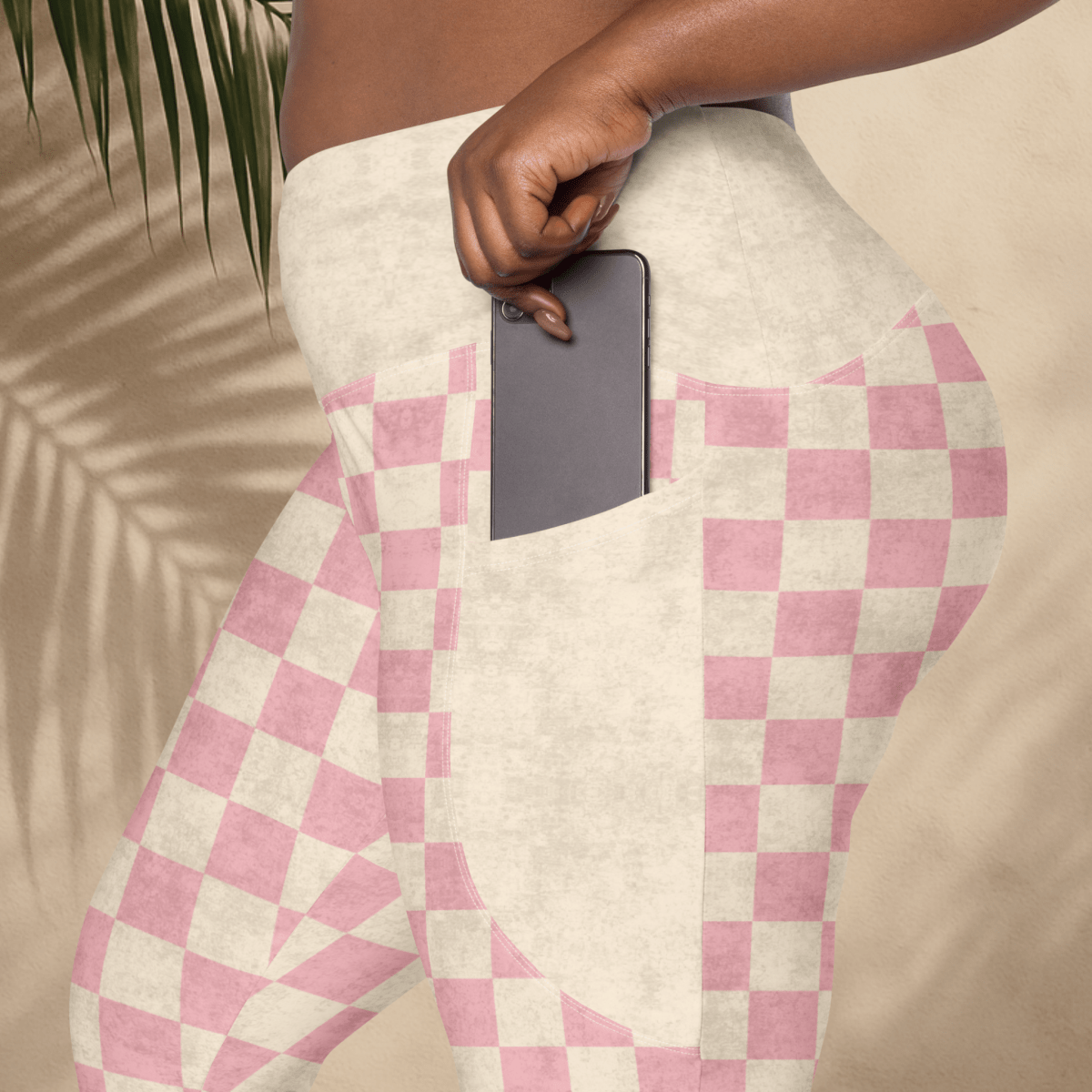 Person wearing pink and cream checkered pants with a blurred background
