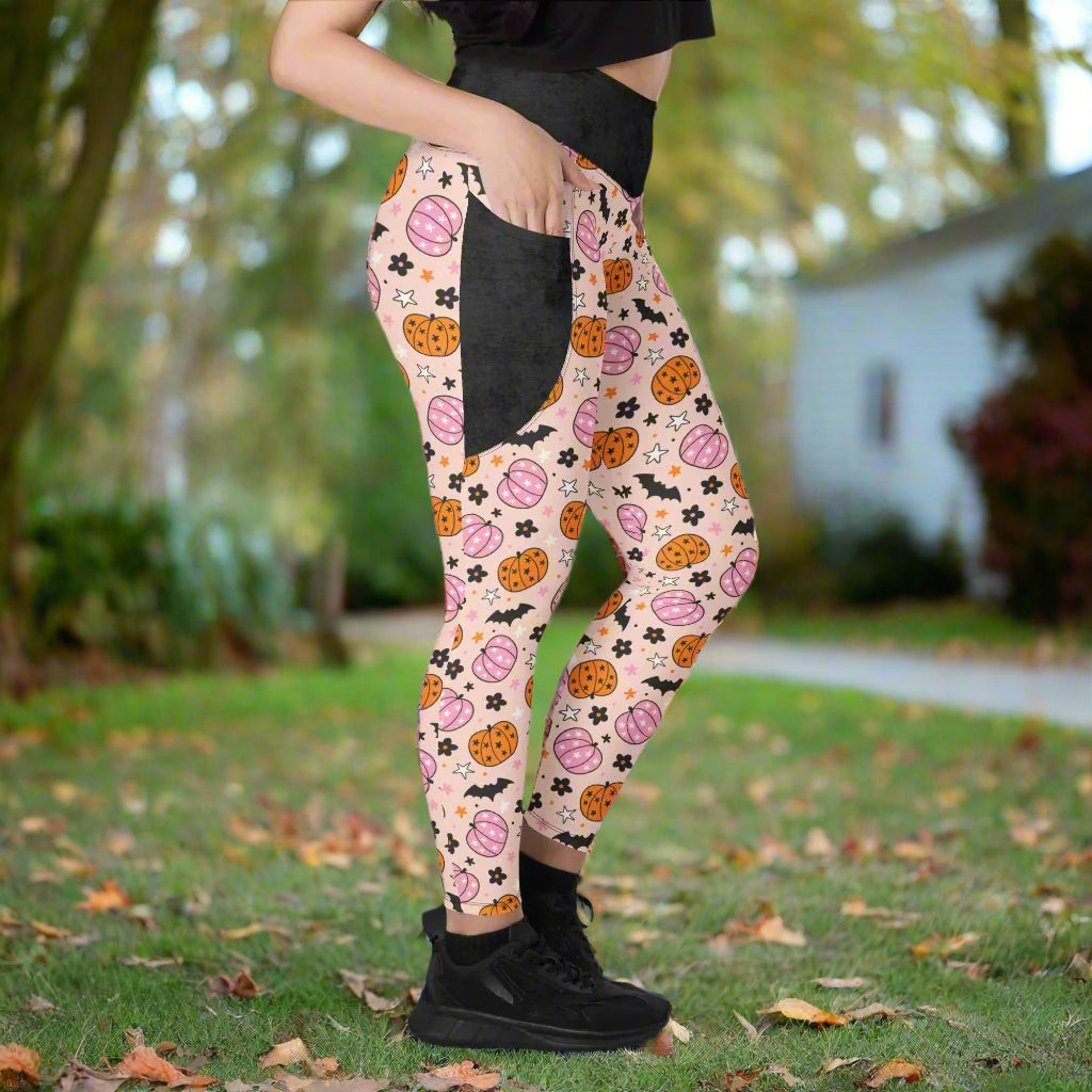 Person wearing halloween leggings with black shoes on a neutral background